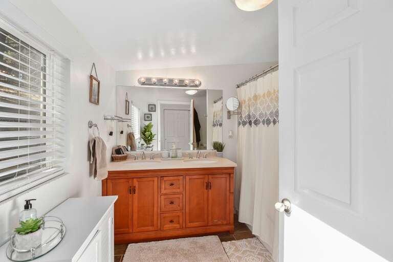 Features an ensuite bathroom with dual vanities and a shower/tub combo for your convenience. Features an ensuite bathroom with dual vanities and a shower/tub combo for your convenience.