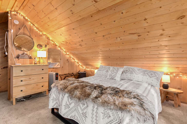 The loft area includes a queen-sized bed and two full-sized beds, offering flexible sleeping arrangements. The loft area includes a queen-sized bed and two full-sized beds, offering flexible sleeping arrangements.