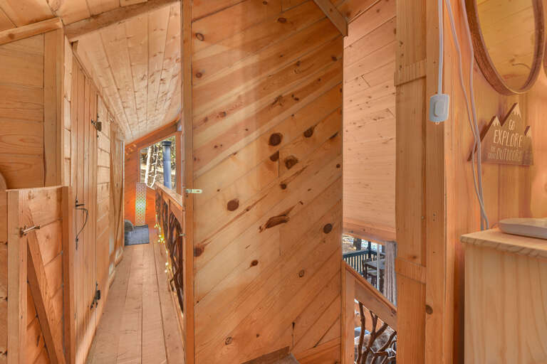 Loft Area: Queen bed and two full beds, plus a small nook with a TV and Super Nintendo—ideal for kids. Includes a half bathroom for guest's convenience. Loft Area: Queen bed and two full beds, plus a small nook with a TV and Super Nintendo—ideal for kids. Includes a half bathroom for guest's convenience.