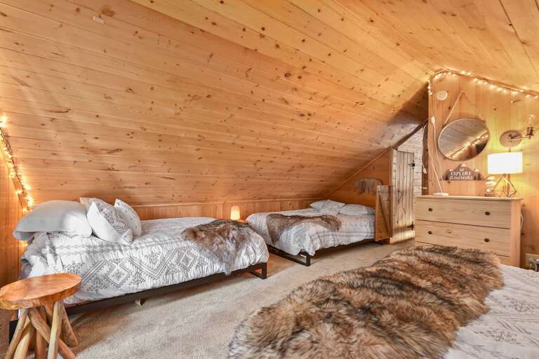 Loft Area: Queen bed and two full beds, plus a small nook with a TV and Super Nintendo—ideal for kids. Includes a half bathroom for guest's convenience. Loft Area: Queen bed and two full beds, plus a small nook with a TV and Super Nintendo—ideal for kids. Includes a half bathroom for guest's convenience.