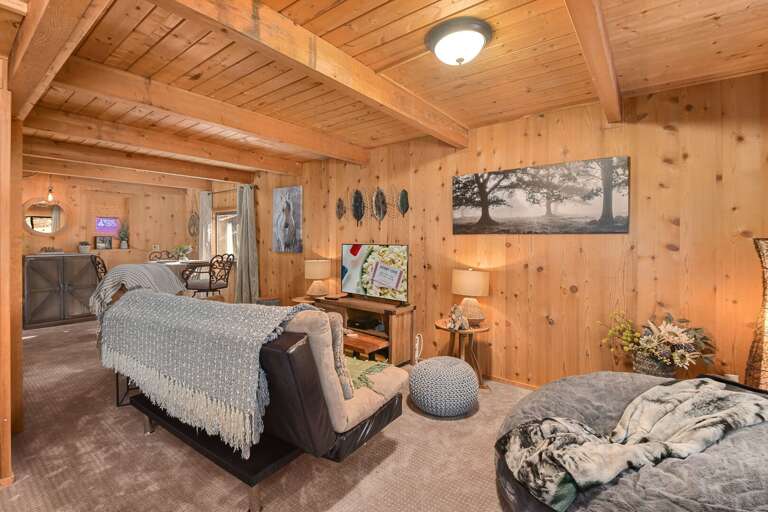 Perfect for families and groups seeking a peaceful escape, it features charming woodsy décor, a cozy fireplace, a pool table, and serene outdoor spaces. Perfect for families and groups seeking a peaceful escape, it features charming woodsy décor, a cozy fireplace, a pool table, and serene outdoor spaces.