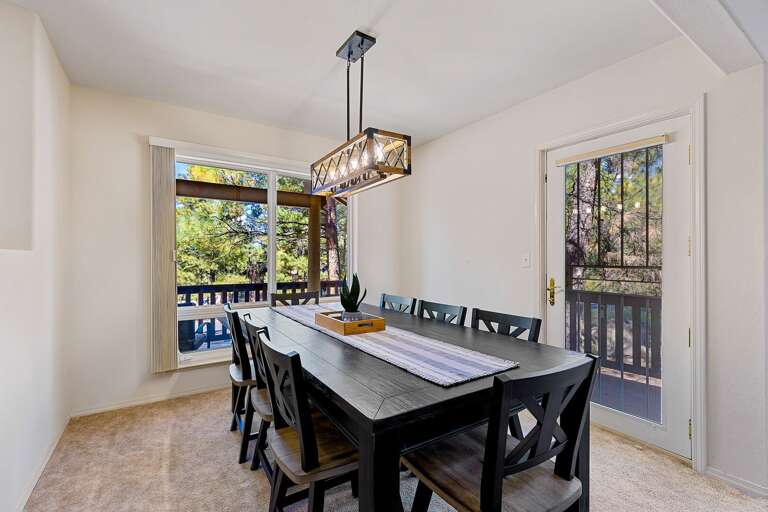 The adjacent dining area offers seating for 8 beneath a modern rustic chandelier, making it ideal for family meals or entertaining friends. The adjacent dining area offers seating for 8 beneath a modern rustic chandelier, making it ideal for family meals or entertaining friends.