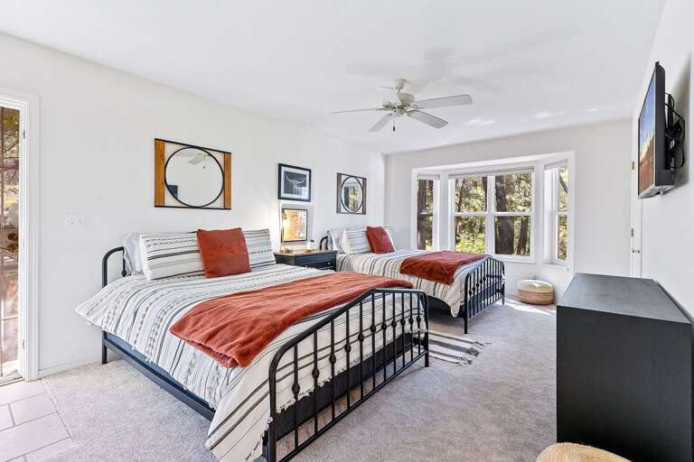 Guest Bedroom 2: Two queen-size beds, smart TV, private backyard access, and access to a shared jack-and-jill bathroom. Guest Bedroom 2: Two queen-size beds, smart TV, private backyard access, and access to a shared jack-and-jill bathroom.