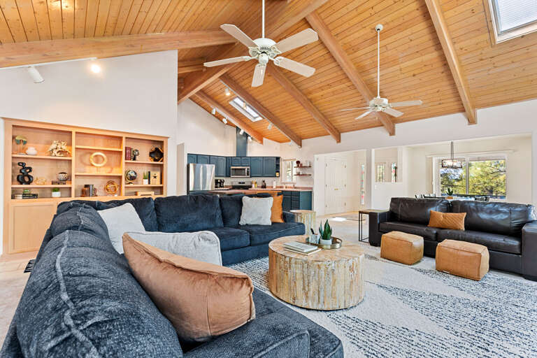 Spacious Interior: Open-concept layout with high ceilings, a luxurious sectional, and a stunning gas fireplace. Spacious Interior: Open-concept layout with high ceilings, a luxurious sectional, and a stunning gas fireplace.