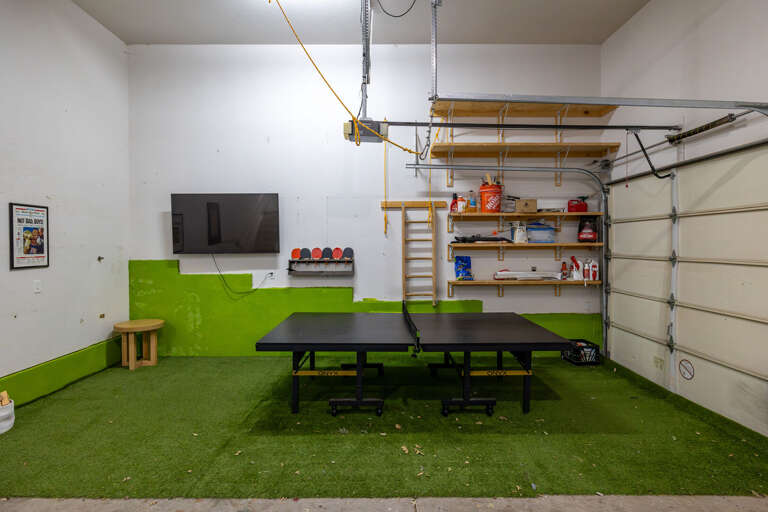 Game Room: Enjoy endless fun in the converted garage, featuring a ping-pong table, smart TV, and a cool hangout spot—ideal for those less-than-perfect weather days. Game Room: Enjoy endless fun in the converted garage, featuring a ping-pong table, smart TV, and a cool hangout spot—ideal for those less-than-perfect weather days.