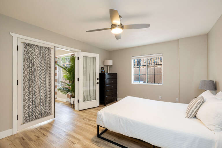 Guest Bedroom 3: Queen-size bed with cozy bedding, patio views, and access to the sunroom. Guest Bedroom 3: Queen-size bed with cozy bedding, patio views, and access to the sunroom.