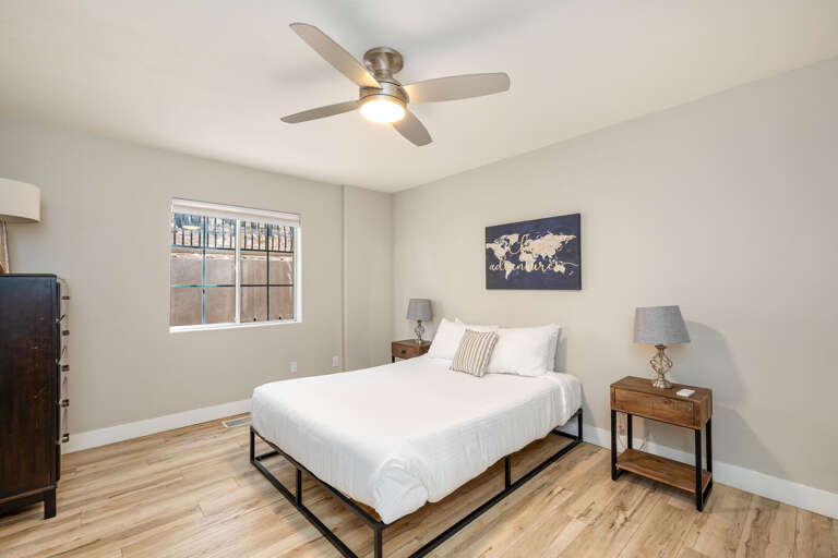 Guest Bedroom 3: Queen-size bed with cozy bedding, patio views, and access to the sunroom. Guest Bedroom 3: Queen-size bed with cozy bedding, patio views, and access to the sunroom.