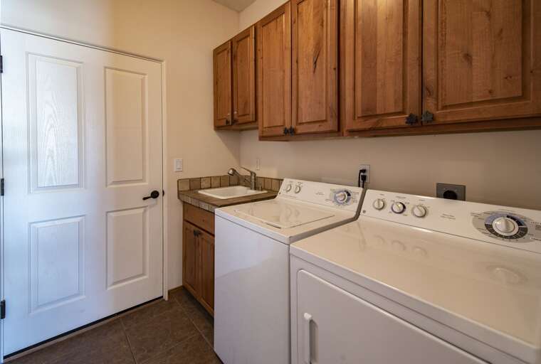 Laundry room w/ sink, washer, and dryer for your convenience