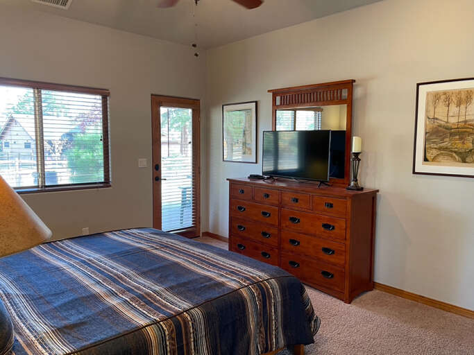 Master Bedroom: King bed, smart TV, walk-in closet, private patio access and en-suite bathroom with a luxurious walk-in shower, jetted bathtub, and dual vanities.