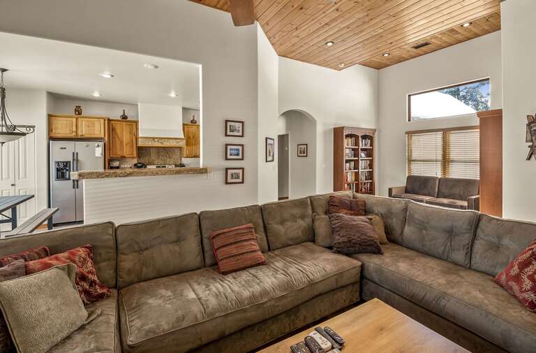 The open-concept layout is designed for relaxation, with a large L-shaped sectional couch perfect