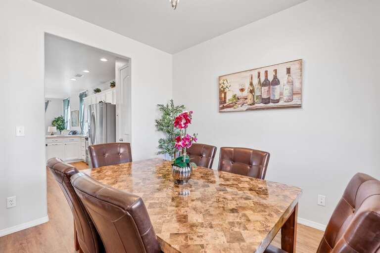 Attached to the dining room is the kitchen, which opens into the living room.