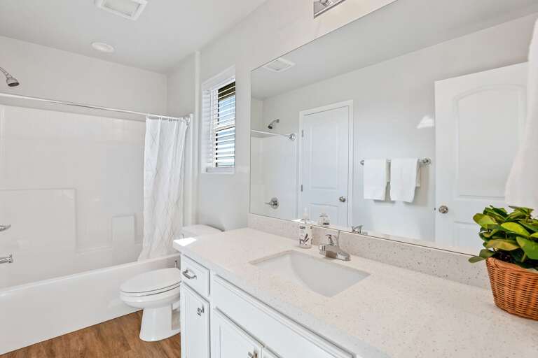 Jack-and-Jill bathroom feature shower/bathtub combos and extra counter space