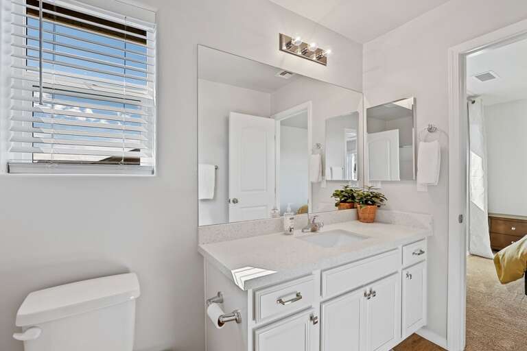 Jack-and-Jill bathroom feature shower/bathtub combos and extra counter space