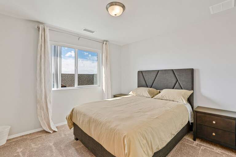 Second Primary Suite: Queen-sized bed and private en-suite bathroom.