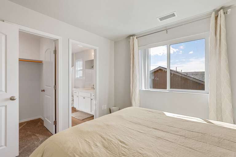 Second Primary Suite: Queen-sized bed and private en-suite bathroom.