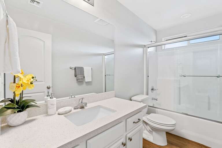 Second Primary Suite: Queen-sized bed and private en-suite bathroom.