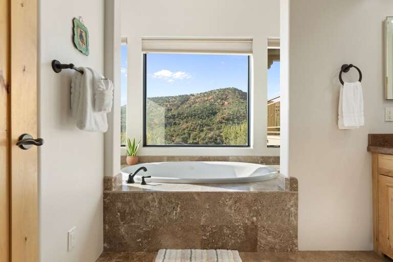 Master En-suite features a luxurious bathroom with a walk-in two-person shower, jacuzzi tub with stunning views, and double sinks. Master En-suite features a luxurious bathroom with a walk-in two-person shower, jacuzzi tub with stunning views, and double sinks.