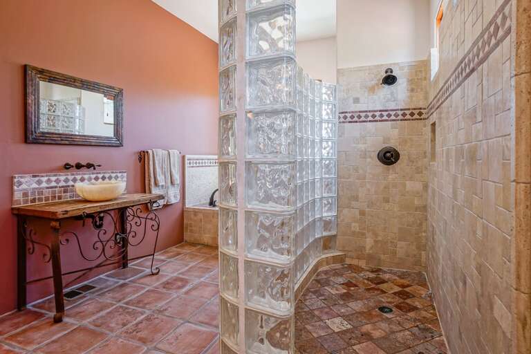 En-suite bathroom featuring a luxury soaking tub for 2, large tiled walk-in shower, double vanity and toilet.