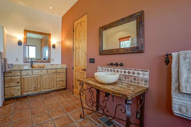 En-suite bathroom featuring a luxury soaking tub for 2, large tiled walk-in shower, double vanity and toilet.