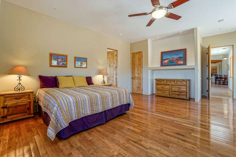 Primary Bedroom 1: King Bed with gas fireplace, an en-suite bathroom featuring a luxury soaking tub for 2, large tiled walk-in shower, double vanity and toilet.