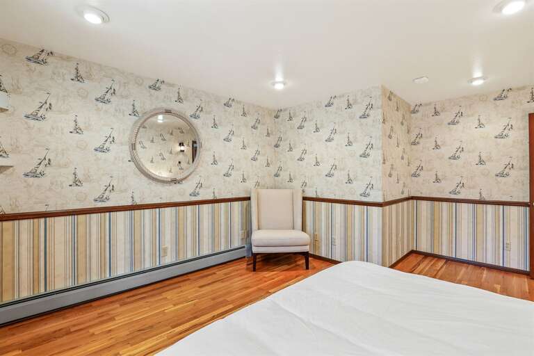 Bedroom 2 (Left Wing): Features a comfortable King-size bed and offers stunning views of the backyard and convenient access to the dedicated hallway bathroom. Bedroom 2 (Left Wing): Features a comfortable King-size bed and offers stunning views of the backyard and convenient access to the dedicated hallway bathroom.