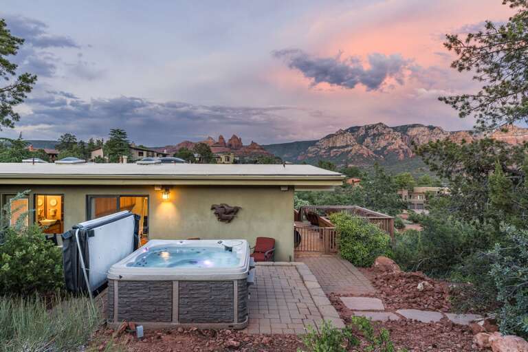 Sunset Skies Over A Serene Setting With A Hot Tub And Picturesque Mountain Backdrop Sunset Skies Over A Serene Setting With A Hot Tub And Picturesque Mountain Backdrop