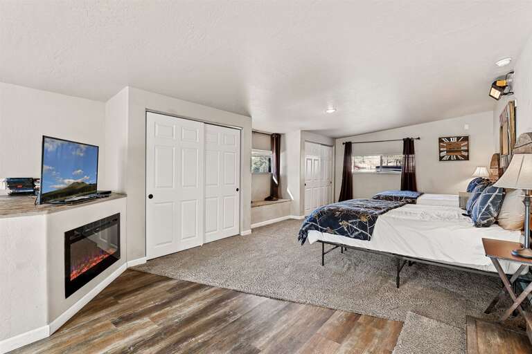 Downstairs -  Master Bedroom 2 - 2 Queen Beds, Ensuite bathroom, electric fireplace and large smart tv and plenty of space to unwind Downstairs -  Master Bedroom 2 - 2 Queen Beds, Ensuite bathroom, electric fireplace and large smart tv and plenty of space to unwind