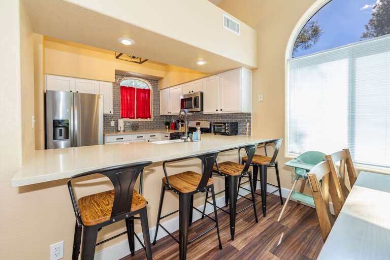 4 stools at the breakfast bar, which is adjacent to the kitchen and dining room table. 4 stools at the breakfast bar, which is adjacent to the kitchen and dining room table.
