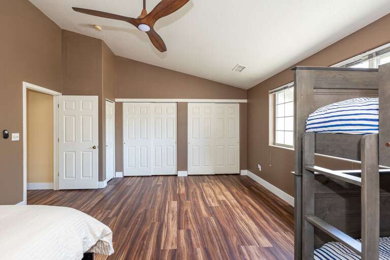 a very large bedroom with a twin-over-twin bunk bed set and queen-sized bed. The other room on this level has a queen-sized bed and a closet. a very large bedroom with a twin-over-twin bunk bed set and queen-sized bed. The other room on this level has a queen-sized bed and a closet.