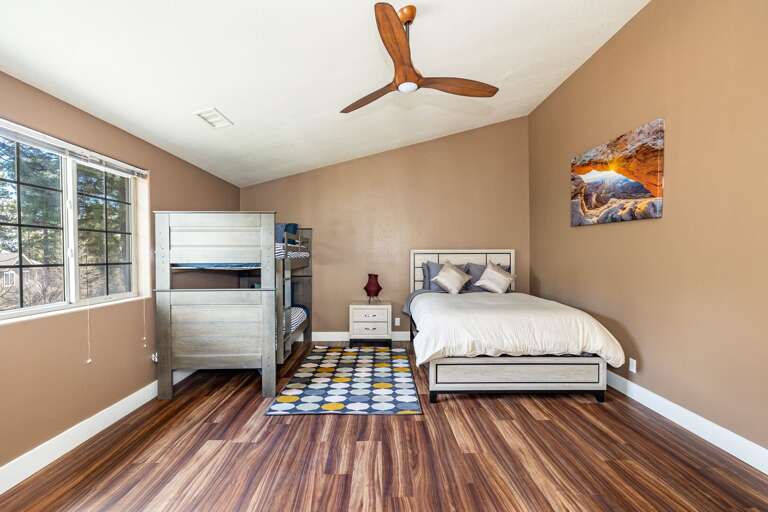 a very large bedroom with a twin-over-twin bunk bed set and queen-sized bed. The other room on this level has a queen-sized bed and a closet. a very large bedroom with a twin-over-twin bunk bed set and queen-sized bed. The other room on this level has a queen-sized bed and a closet.