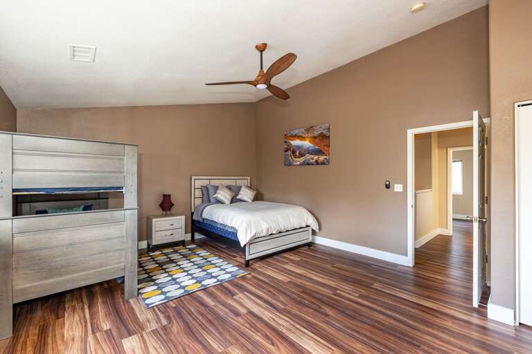 a very large bedroom with a twin-over-twin bunk bed set and queen-sized bed. The other room on this level has a queen-sized bed and a closet. a very large bedroom with a twin-over-twin bunk bed set and queen-sized bed. The other room on this level has a queen-sized bed and a closet.