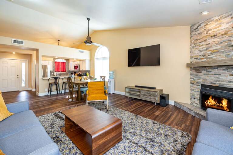 With one sofa, one loveseat and an oversized chair encircling the gas fireplace and a large flat-screen TV mounted on the wall. With one sofa, one loveseat and an oversized chair encircling the gas fireplace and a large flat-screen TV mounted on the wall.