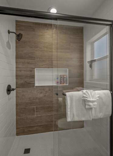 2nd Bedroom: King bed with a desk and lake views. An attached en-suite bathroom includes twin quartz vanities and a glass walk-in shower. 2nd Bedroom: King bed with a desk and lake views. An attached en-suite bathroom includes twin quartz vanities and a glass walk-in shower.