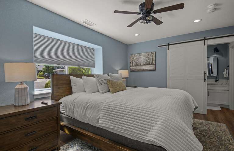 2nd Bedroom: King bed with a desk and lake views. An attached en-suite bathroom includes twin quartz vanities and a glass walk-in shower. 2nd Bedroom: King bed with a desk and lake views. An attached en-suite bathroom includes twin quartz vanities and a glass walk-in shower.