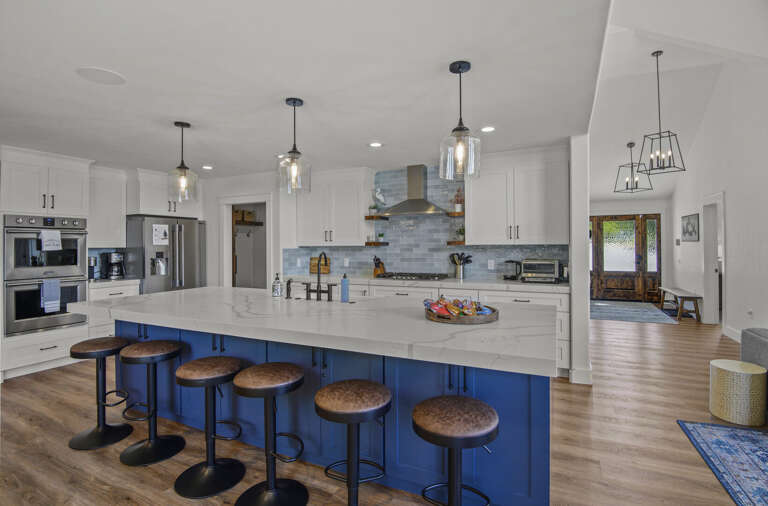 stunning white marbled quartz countertops and contrasting white and blue cabinetry hold a farmhouse stunning white marbled quartz countertops and contrasting white and blue cabinetry hold a farmhouse