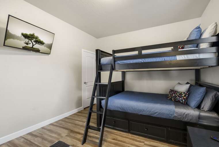 Ground-Level Bunk Room: Queen-sized Bunk Beds for 4, Smart TV, walk-in closet, and an en suite bathroom with shower/tub combo. Ground-Level Bunk Room: Queen-sized Bunk Beds for 4, Smart TV, walk-in closet, and an en suite bathroom with shower/tub combo.