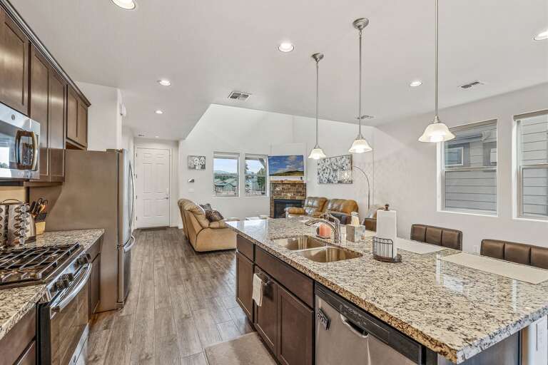 double sink, a dishwasher, and four slice toaster, kettle, Keurig, dark cabinetry and granite countertops double sink, a dishwasher, and four slice toaster, kettle, Keurig, dark cabinetry and granite countertops