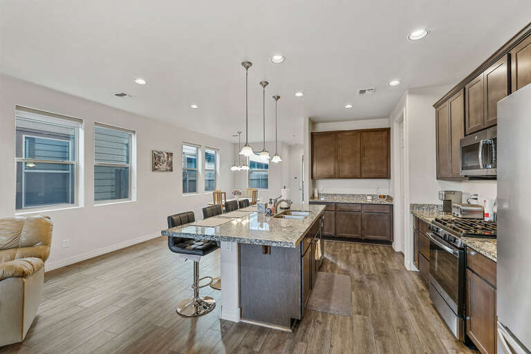 stainless steel appliances, a double sink, a dishwasher, and four slice toaster, kettle, Keurig, dark cabinetry and granite countertops stainless steel appliances, a double sink, a dishwasher, and four slice toaster, kettle, Keurig, dark cabinetry and granite countertops