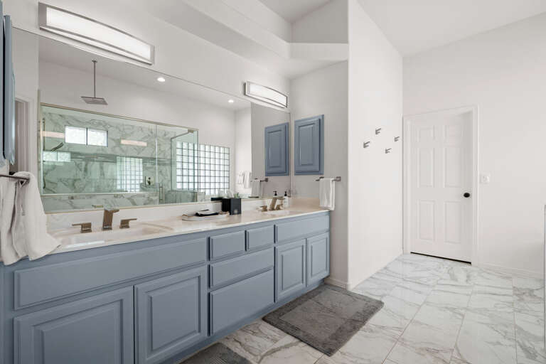 Main suite bathroom with double vanity sinks.