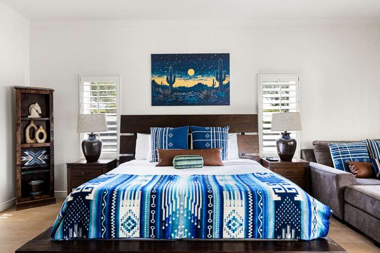 Retreat to the spacious primary suite, featuring a king bed, cozy sitting area, and plenty of room to relax and recharge.