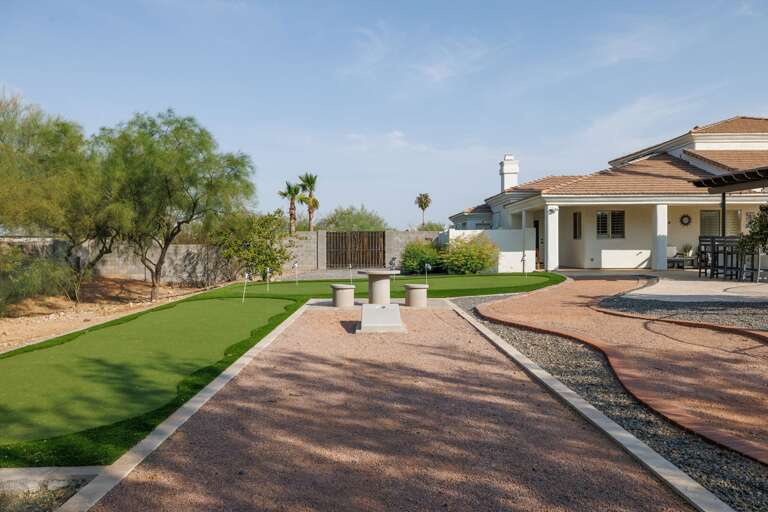 Stroll the private backyard path, practice your corn hole toss, or gather around the outdoor seating area—all surrounded by peaceful desert landscaping.