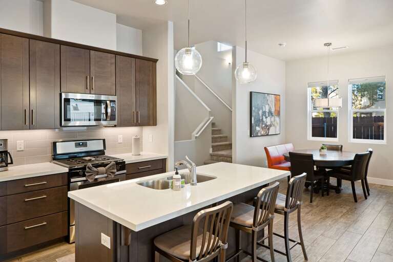 Cookware stocked kitchen with an island bar top.