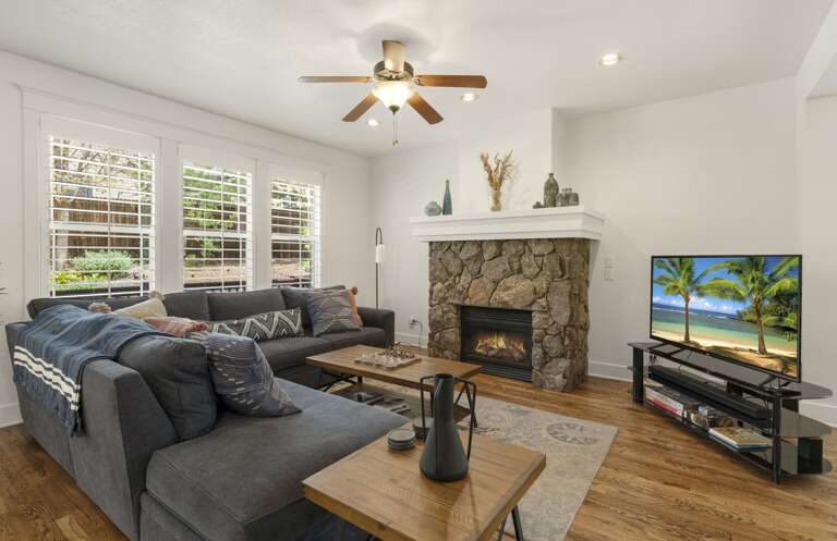 Enjoy spacious, open-concept living designed for comfort and connection. Gather around the L-shaped sofa and wood coffee table, basking in the warmth of the gas stone fireplace. Enjoy spacious, open-concept living designed for comfort and connection. Gather around the L-shaped sofa and wood coffee table, basking in the warmth of the gas stone fireplace.