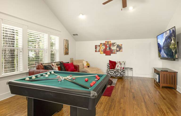 A phenomenal game room with a pool table and arcades A phenomenal game room with a pool table and arcades