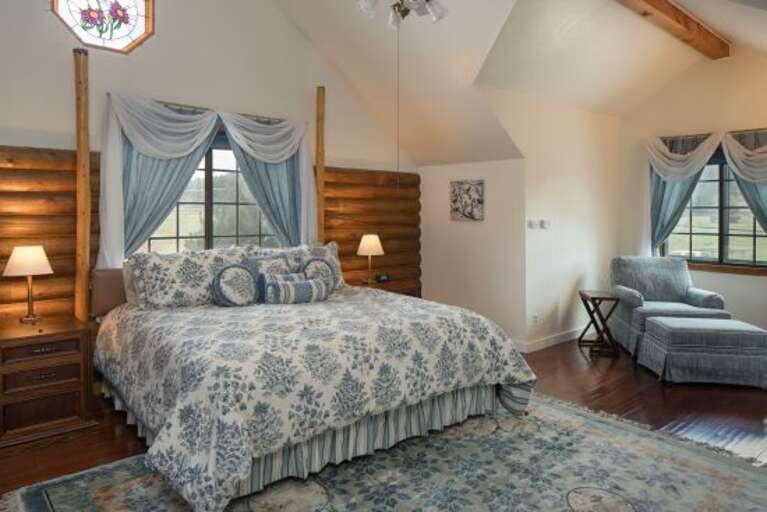 Blue Room: A cozy room with a King-sized bed and beautiful stained-glass windows. It features a