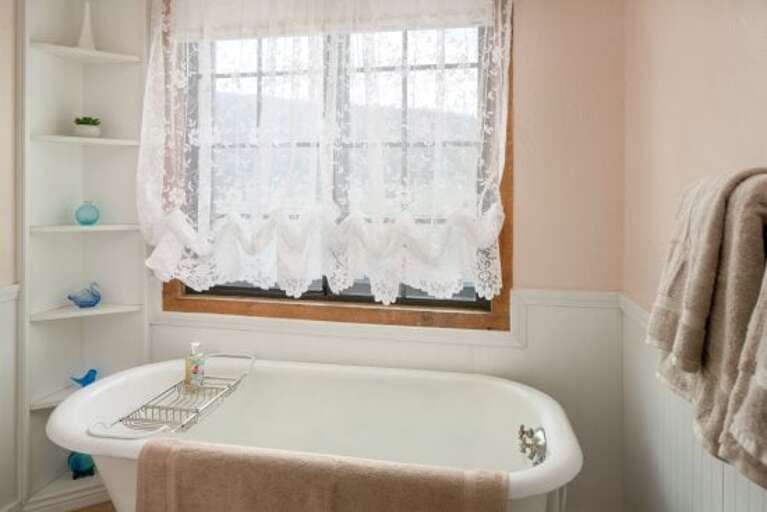 Fourth Bedroom: This elegant room includes a King-sized bed, faux-painted walls, and a bathroom with a claw-foot tub and separate walk-in shower for a spa-like feel.