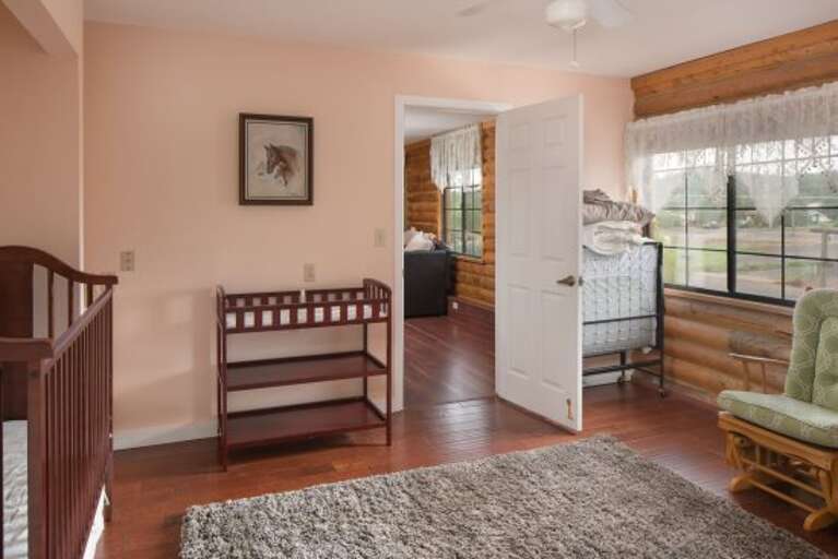Master Suite: It includes an adjacent nursery with crib and changing table and a spacious en-suite bathroom with dual sinks and a shower/tub combo for ultimate comfort.