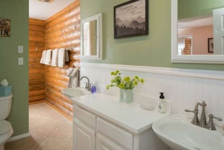 Master Suite: It includes an adjacent nursery with crib and changing table and a spacious en-suite bathroom with dual sinks and a shower/tub combo for ultimate comfort.