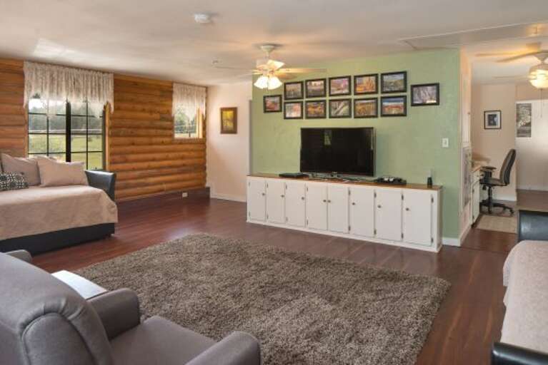 Master Suite: A lavish and exceptionally spacious environment with a King-sized bed, 2 Twin with Trundle beds (Room Sleeps 6), a massage chair, and a dedicated office workspace.