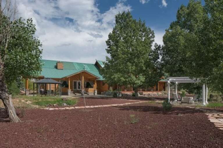 Step outside to enjoy the peaceful backyard, featuring a gazebo with seating for six and a